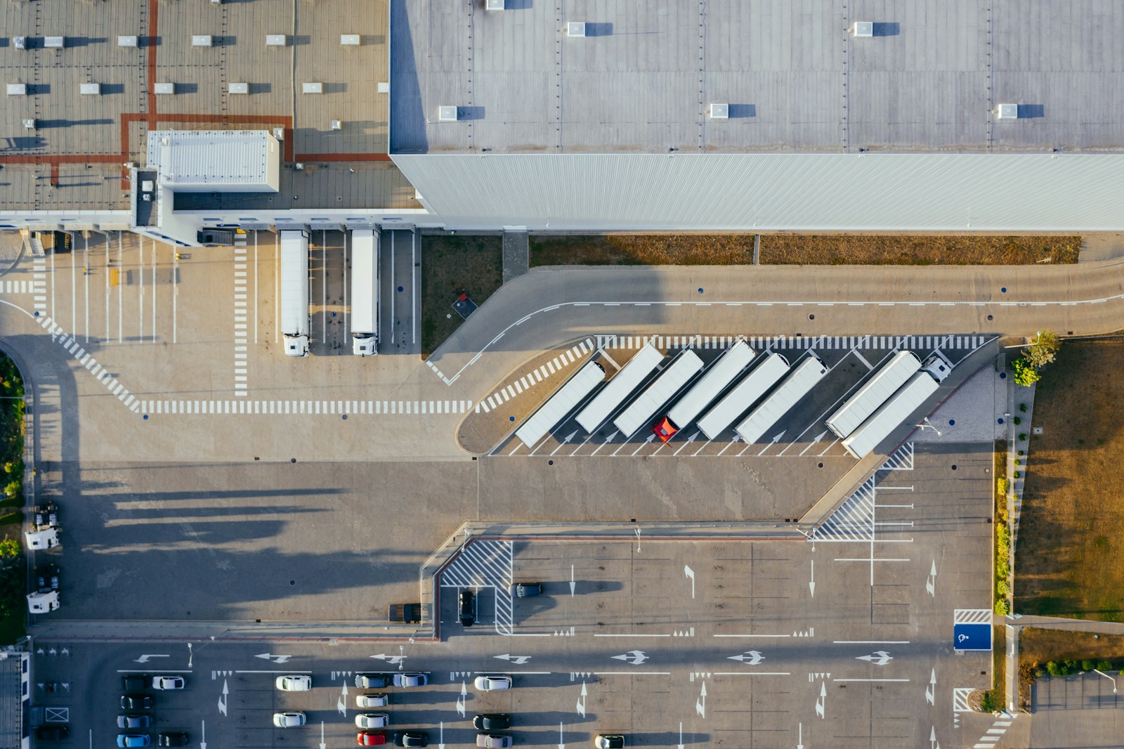 Trucks and trailers parked at a distribution depot